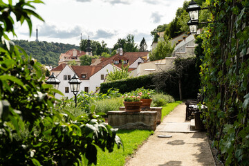 Prague, Czech Republic – August 6, 2025: A view from the terraced Palace Gardens below Prague Castle, with the Petřín Lookout Tower visible on the hill above the rooftops of the Lesser Town