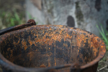 a very old rusty bucket