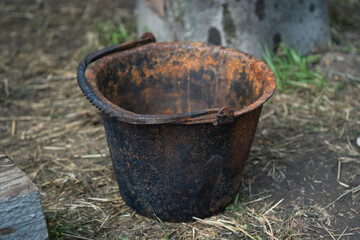 a very old rusty bucket
