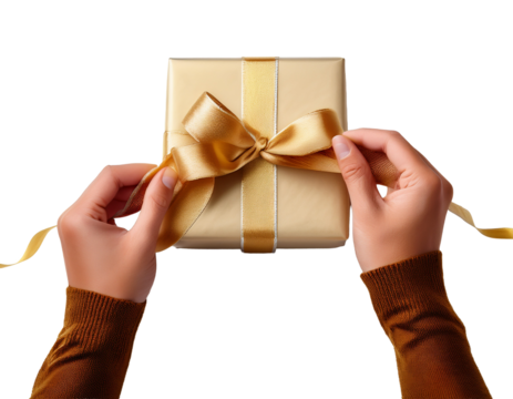 Human hands tying a gold ribbon around gift box, white background