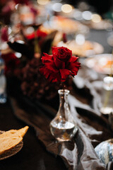 Red rose in glass vase elegant centerpiece on luxury banquet table