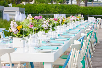 Close up outdoor image of dinner table set up at wedding reception.