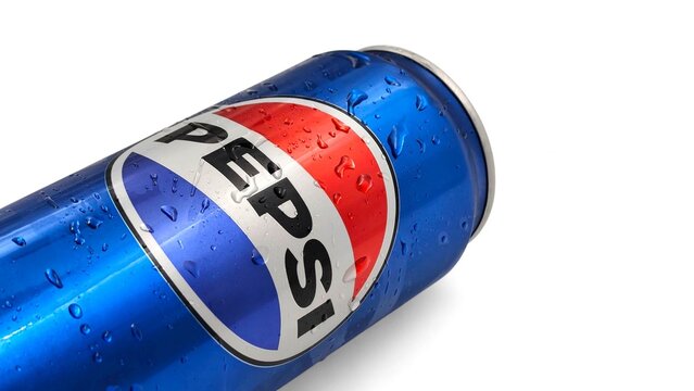 Closeup view of a refreshing Pepsi regular soda can with water droplets, isolated on white background with space for text.