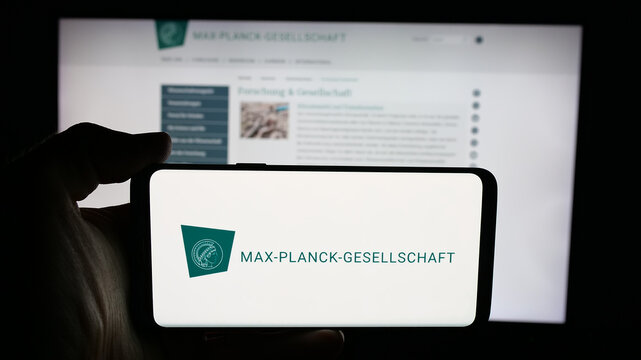Stuttgart, Germany - 11-01-2025: Person holding cellphone with logo of research organisation Max-Planck-Gesellschaft on screen in front of webpage. Focus on phone display.