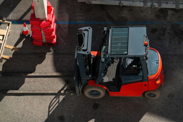 Top-down view of a red forklift truck on an industrial yard © natatravel