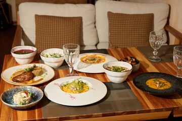 Enjoy a gourmet dinner with diverse cuisines and elegant glassware for everyone
