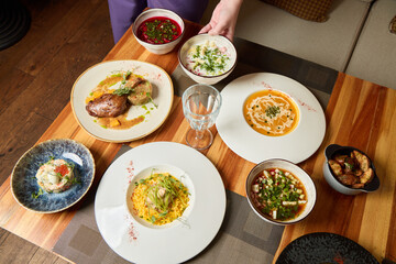 A Delicious Spread Featuring a Bounty of International Dishes Arranged on a Wooden Table