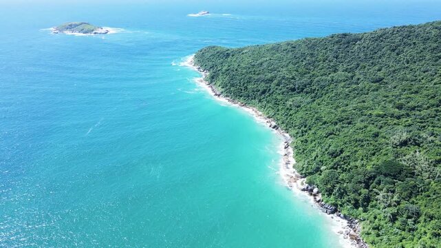 Aerial view of english hill on English Beach in Florian&oacute;polis, Santa Catarina, in the fishermen's Corner and Badejo Island with turquoise blue ocean.