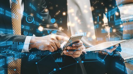 Business professionals engage with technology, analyzing data through mobile devices amidst a backdrop of dynamic graphic overlays representing analytics and insights. Xenic - Powered by Adobe