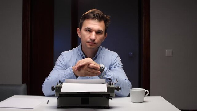 man writing anxiously, anxious man in office focuses on watch while working frantically
