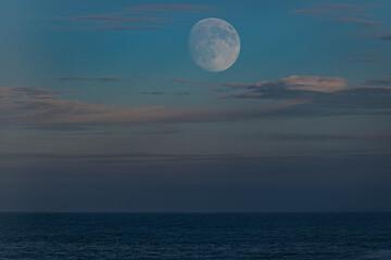 Photographing big waves, birds flying at sea, and the almost full moon!