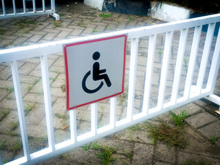 A parking lot with a disability handicap parking sign