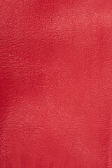 Red natural leather dyed in red color macro background. Red background vertical.