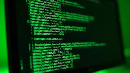Closeup of green glowing computer code scrolling on a dark screen depicting a hackers interface or a complex data stream in a digital environment. - Powered by Adobe
