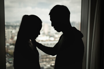 A man gently comforting a sad woman during a difficult emotional moment, symbolizing support,...