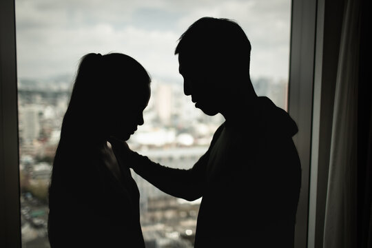A man gently comforting a sad woman during a difficult emotional moment, symbolizing support, relationship problems, stress, and compassion.