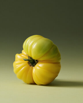 Yellow Heirloom Tomatoes Painterly Still Life on Green Seamless background. Film grain