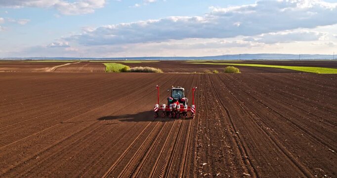 Tractor seeding field preparing soil for planting crops
