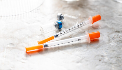 Close up of Single Use Syringes with Small Glass Vials