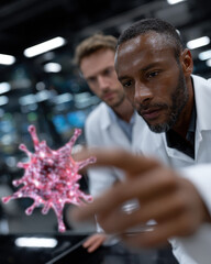 Two scientists in lab coats attentively observe a colorful model of a virus, embodying the spirit of curiosity and exploration in the field of virology and infectious diseases.