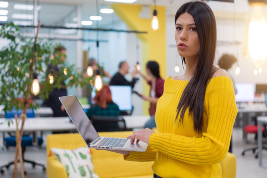 Focused businesswoman working on computer in creative workspace