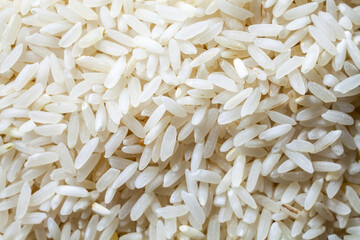 Uncooked white long grain rice background texture