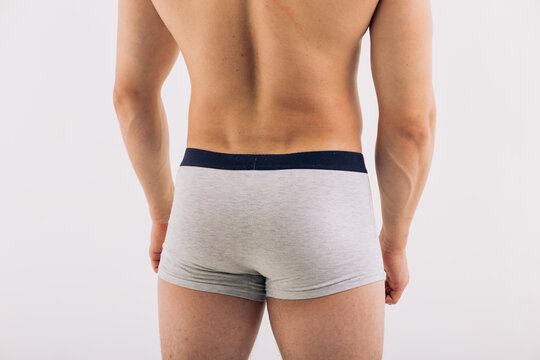 body parts: male ass in close-up in gray boxers on a white isolated background. male health: prevention of prostatitis and hemorrhoids
