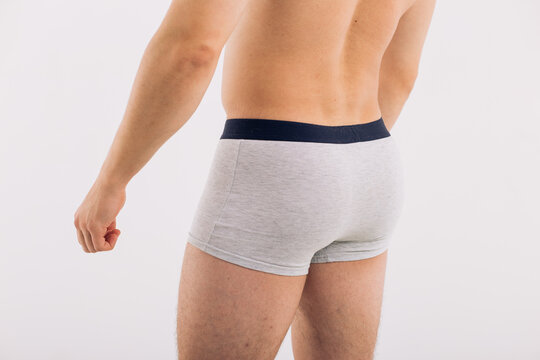 body parts: male ass in close-up in gray boxers on a white isolated background. male health: prevention of prostatitis and hemorrhoids