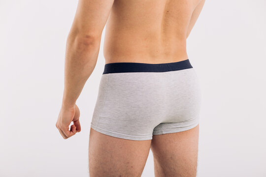 body parts: male ass in close-up in gray boxers on a white isolated background. male health: prevention of prostatitis and hemorrhoids