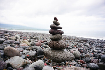 Stone pebble balancing in the beach. Sea rocks formation for stability and life balance concept. Peace and harmony symbol. Stack of rock or stones. Be balance concepts.