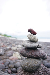Stone pebble balancing in the beach. Sea rocks formation for stability and life balance concept. Peace and harmony symbol. Stack of rock or stones. Be balance concepts.