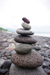 Stone pebble balancing in the beach. Sea rocks formation for stability and life balance concept. Peace and harmony symbol. Stack of rock or stones. Be balance concept.