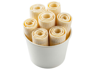 Sweet vanilla rolled ice cream dessert in a white cup, a refreshing frozen treat