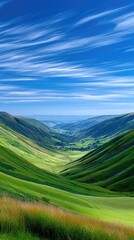 Vast Green Valley Under a Bright Blue Sky with Wispy White Clouds Illuminated by Sunlight Creating Dramatic Shadows Across the Rolling Hills and Distant Townscape