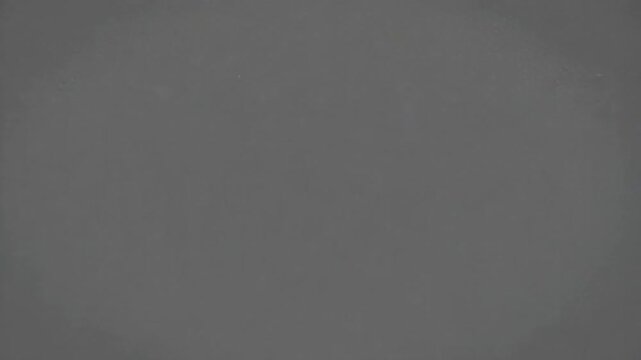 Closeup of a textured gray surface with a pattern of small, irregularly shaped holes, creating a porous or spongelike appearance, possibly indicating a material used for filtration or sound absorption