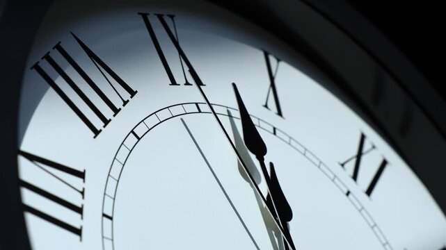 Sun and sky reflecting in the watch during the time passing by. Time lapse on a modern white Clock on white.  Close up to a wall clock, with running time pointer. Wall clock show the running time. 