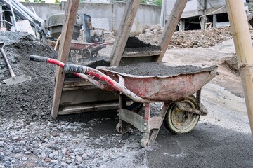 Wheelbarrow filled with gravel at construction site in daylight condition