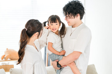 Fototapeta premium Young Asian couple holding their daughter at home, family, parent and child, family 