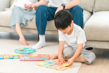 Family playing in the living room of their own home, parent and child (childcare, child rearing)
