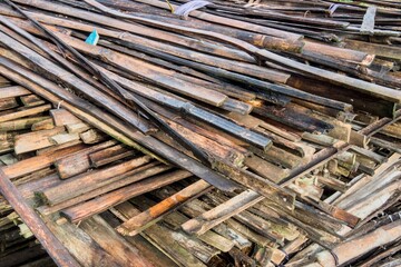 Pile of weathered wood planks and scraps for recycling or construction