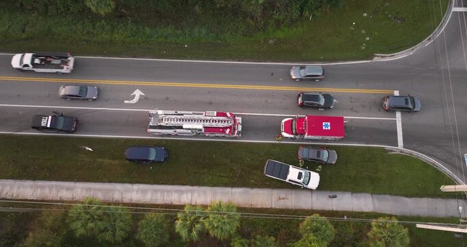 Car accident on city street in Florida. Result of distracted driving and speeding. Emergency services at vehicle crash in USA.