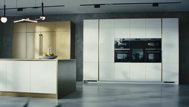Modern kitchen interior with white and gold cabinets and black appliances and track lighting