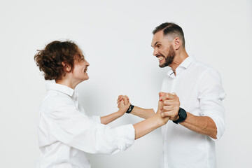 Obraz premium A professional business scene with two men in white shirts sharing a friendly fist bump against an isolated white background, conveying teamwork, confidence, and positive emotion in a modern