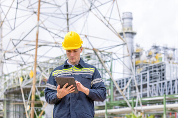Engineers male, female working with tablet in industry oil refinery oil, gas refinery background,...