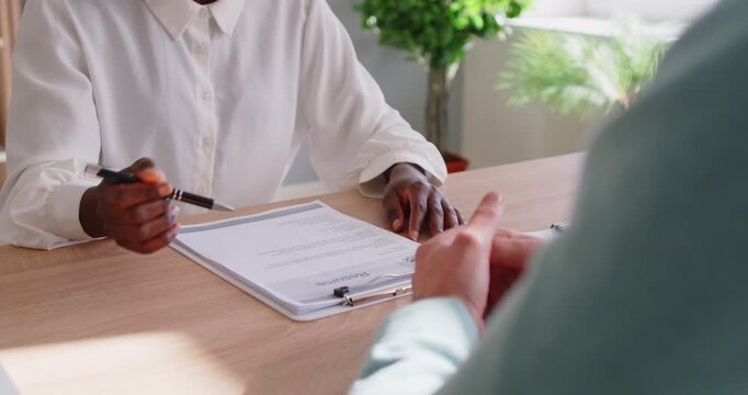 African american consultant woman hand close up, doctor provides expert advice professionally, information to business client, shaking male as greeting, deal, support, congratulation, agreement