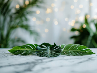 Tropical leaves arranged on marble surface with blurred plants and lights behind, natural light and shallow depth, copy space for product branding.