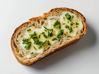 Slice of crusty bread topped with creamy butter and chopped herbs on parchment, overhead natural light, food styling ideal for recipe or menu use.