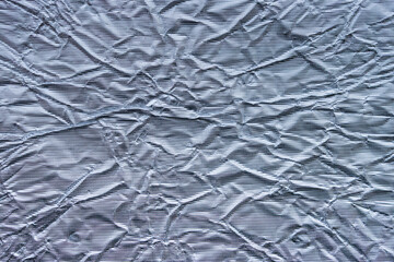 Shiny metal silver gray foil leaf crumpled texture background