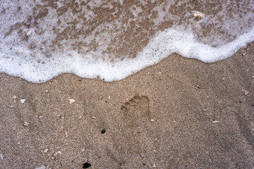 flat lay of sea foam on the sand beach