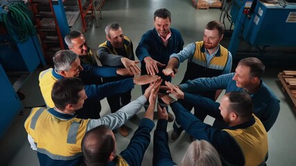 Team of workers in a circle with hands joined together, symbolizing teamwork and collaboration Stock Video